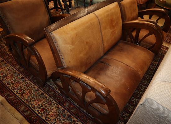 An oak framed three piece French leather upholstered suite